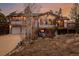 Stunning exterior view of a two-story home with a large deck and mountain views at sunset at 37 High View Ln, Boulder, CO 80302