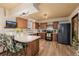 Well-lit kitchen with wood cabinets, a black refrigerator, marble countertops, and modern appliances at 37 High View Ln, Boulder, CO 80302