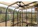 Bright sunroom with large black windows and a ceiling fan, showcasing views of the surrounding forest at 37 High View Ln, Boulder, CO 80302