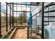 Bright sunroom with flagstone floor, spiral staircase, seating, and views of the outdoor scenery at 37 High View Ln, Boulder, CO 80302