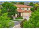Stunning aerial view of a two-story home with mature trees and lush landscaping in a desirable neighborhood at 16650 E 107Th Ct, Commerce City, CO 80022