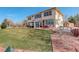 Beautiful backyard featuring a spacious lawn, large patio with outdoor dining and built in grill at 16650 E 107Th Ct, Commerce City, CO 80022