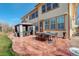 Spacious backyard with a large patio, outdoor dining set, and a gazebo at 16650 E 107Th Ct, Commerce City, CO 80022