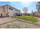 Backyard with grass, privacy fence, large tree and gravel at 16650 E 107Th Ct, Commerce City, CO 80022