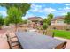 Inviting backyard with patio, dining set, play structure, and well-maintained landscaping at 16650 E 107Th Ct, Commerce City, CO 80022