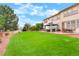 Large backyard with patio, gazebo, mature trees, and green grass, perfect for outdoor enjoyment at 16650 E 107Th Ct, Commerce City, CO 80022