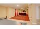 Finished basement with a ping pong table, red carpet and a brown leather sofa at 16650 E 107Th Ct, Commerce City, CO 80022