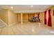 Large finished basement area with tiled floors, perfect for a home gym or recreation room at 16650 E 107Th Ct, Commerce City, CO 80022