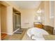 Large bathroom with soaking tub, shower and double vanity on tile floor at 16650 E 107Th Ct, Commerce City, CO 80022