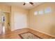 Bedroom with wood floor, white sliding door closet, ceiling fan and three windows at 16650 E 107Th Ct, Commerce City, CO 80022