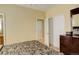 Bedroom with neutral walls, a closet, and a dark wood dresser at 16650 E 107Th Ct, Commerce City, CO 80022