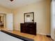 Bedroom with hardwood floors and a dresser with mirror at 16650 E 107Th Ct, Commerce City, CO 80022