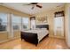 Bright bedroom with multiple windows, modern accents, and hardwood floors at 16650 E 107Th Ct, Commerce City, CO 80022