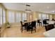 Bright dining area with a modern chandelier, four chairs, and windows with plantation shutters at 16650 E 107Th Ct, Commerce City, CO 80022