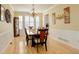 Elegant dining room with a chandelier, large windows, and classic wainscoting at 16650 E 107Th Ct, Commerce City, CO 80022