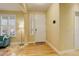 Inviting entryway with a white front door, sidelight window, and light hardwood floors at 16650 E 107Th Ct, Commerce City, CO 80022