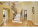 Foyer with wooden staircase and neutral colored walls at 16650 E 107Th Ct, Commerce City, CO 80022