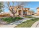 Inviting two-story home featuring a well-manicured lawn, brick accents, and a charming covered porch at 16650 E 107Th Ct, Commerce City, CO 80022
