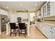 Modern kitchen with stainless steel appliances, white cabinets, and eat-in bar seating at 16650 E 107Th Ct, Commerce City, CO 80022