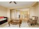 Bright living room featuring a ceiling fan, neutral walls, and a view of the upstairs landing at 16650 E 107Th Ct, Commerce City, CO 80022