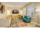 Sunlit living room showcasing stylish furnishings, neutral decor, and beautiful tile flooring at 16650 E 107Th Ct, Commerce City, CO 80022