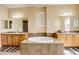 Spacious main bathroom with double vanities, soaking tub, and neutral color palette at 16650 E 107Th Ct, Commerce City, CO 80022