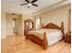 Spacious main bedroom with hardwood floors, a ceiling fan, and a tray ceiling at 16650 E 107Th Ct, Commerce City, CO 80022