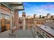 Urban condo balcony featuring a skyline view, water tower, and metal railing overlooking a historic brick neighborhood at 1890 Wynkoop St # 806, Denver, CO 80202
