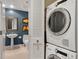 This bathroom features a stylish pedestal sink with a stacked washer and dryer at 1890 Wynkoop St # 806, Denver, CO 80202