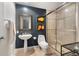 Stylish bathroom featuring a pedestal sink, framed mirror, and a glass-enclosed shower at 1890 Wynkoop St # 806, Denver, CO 80202