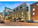 Exterior of building showing balconies, large windows, and street view with parked cars under a twilight sky at 1890 Wynkoop St # 806, Denver, CO 80202