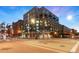 Corner building with brick and glass facade, street lights, and visible crosswalks under a clear blue sky at 1890 Wynkoop St # 806, Denver, CO 80202