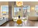 Bright dining area with city views, modern lighting, and concrete pillars at 1890 Wynkoop St # 806, Denver, CO 80202