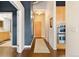 Inviting hallway with hardwood floors, neutral walls, and stylish light fixtures leading to other rooms at 1890 Wynkoop St # 806, Denver, CO 80202
