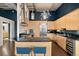 Modern kitchen with stainless steel appliances, black countertops, and custom wood cabinets at 1890 Wynkoop St # 806, Denver, CO 80202