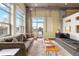 Bright living room with balcony, large windows providing city views, and a seating area with comfortable sofas at 1890 Wynkoop St # 806, Denver, CO 80202