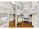 Spacious walk-in closet with custom shelving, hardwood floors and ample storage space at 1890 Wynkoop St # 806, Denver, CO 80202