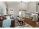 Bright living room featuring vaulted ceilings, hardwood floors, and modern décor at 21714 Silver Meadow Ln, Parker, CO 80138