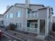 Exterior view of condo building with stairs and balcony at 8437 Thunder Ridge Way # 102, Highlands Ranch, CO 80126