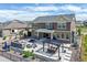 Aerial view of the backyard, highlighting the outdoor kitchen, seating area, pergola, and meticulously landscaped yard at 20503 E 50Th Pl, Denver, CO 80249