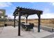 Backyard featuring a pergola with outdoor seating and lighting overlooking natural space at 20503 E 50Th Pl, Denver, CO 80249