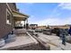 Backyard featuring a stone patio, outdoor kitchen, gas grill, fire pit, fountain, and pergola at 20503 E 50Th Pl, Denver, CO 80249