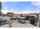 Backyard featuring a stone patio, outdoor kitchen, gas grill, fire pit, and pergola at 20503 E 50Th Pl, Denver, CO 80249