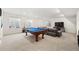 Finished basement featuring a pool table, seating, and entertainment area with natural light at 20503 E 50Th Pl, Denver, CO 80249