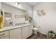 Well-lit half bathroom with granite countertop, stylish decor, and modern fixtures at 20503 E 50Th Pl, Denver, CO 80249