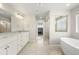 Spacious bathroom with double vanity, soaking tub, and glass shower at 20503 E 50Th Pl, Denver, CO 80249