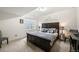 Bedroom featuring a large bed, neutral walls and flooring, and natural light at 20503 E 50Th Pl, Denver, CO 80249