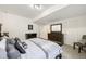 Bedroom features a dark dresser, mirror, and plush bed at 20503 E 50Th Pl, Denver, CO 80249