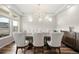 Elegant dining room with a stylish chandelier, hardwood floors, and large windows at 20503 E 50Th Pl, Denver, CO 80249