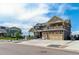 Two-story home featuring a three-car garage, balcony, and low maintenance front yard at 20503 E 50Th Pl, Denver, CO 80249
